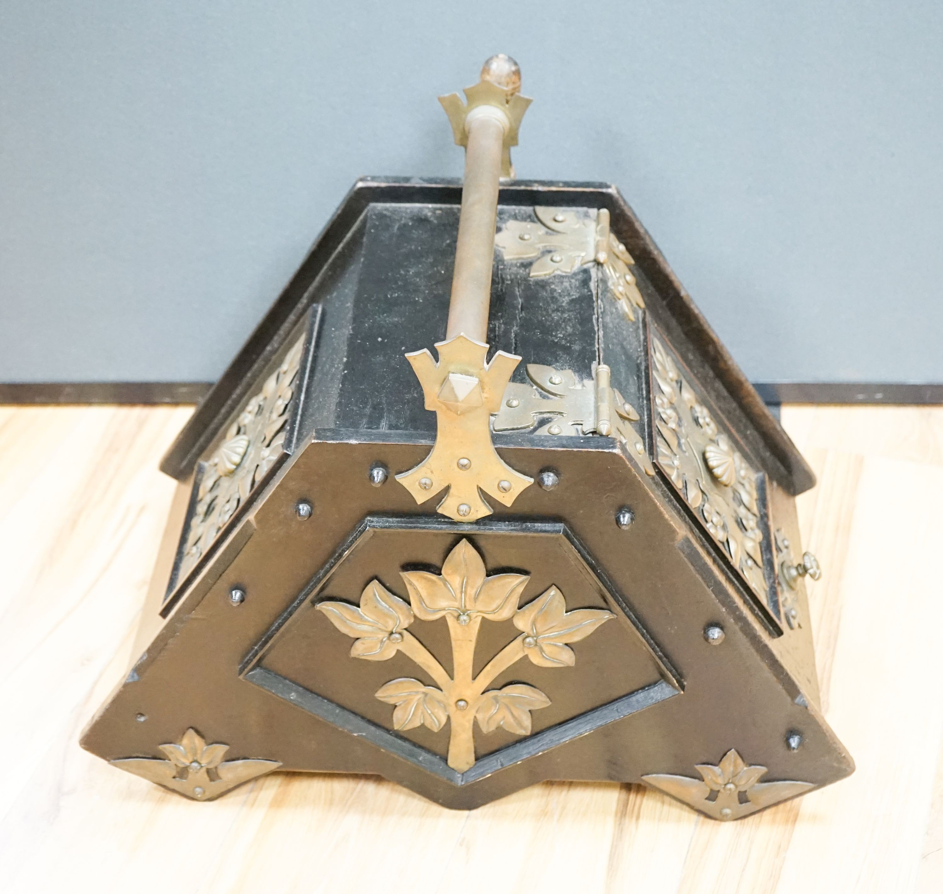 A Victorian Christopher Dresser design brass mounted ebonised coal scuttle, manufactured by Benham & Froud, 40 cm wide